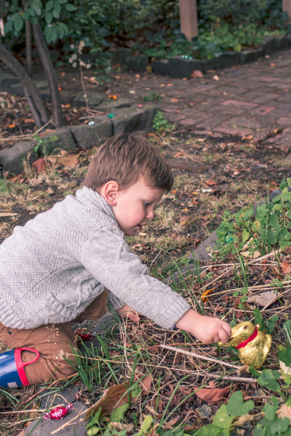 Toddler wearing vintage boys knitwear cardigan for Autumn easter egg hunt