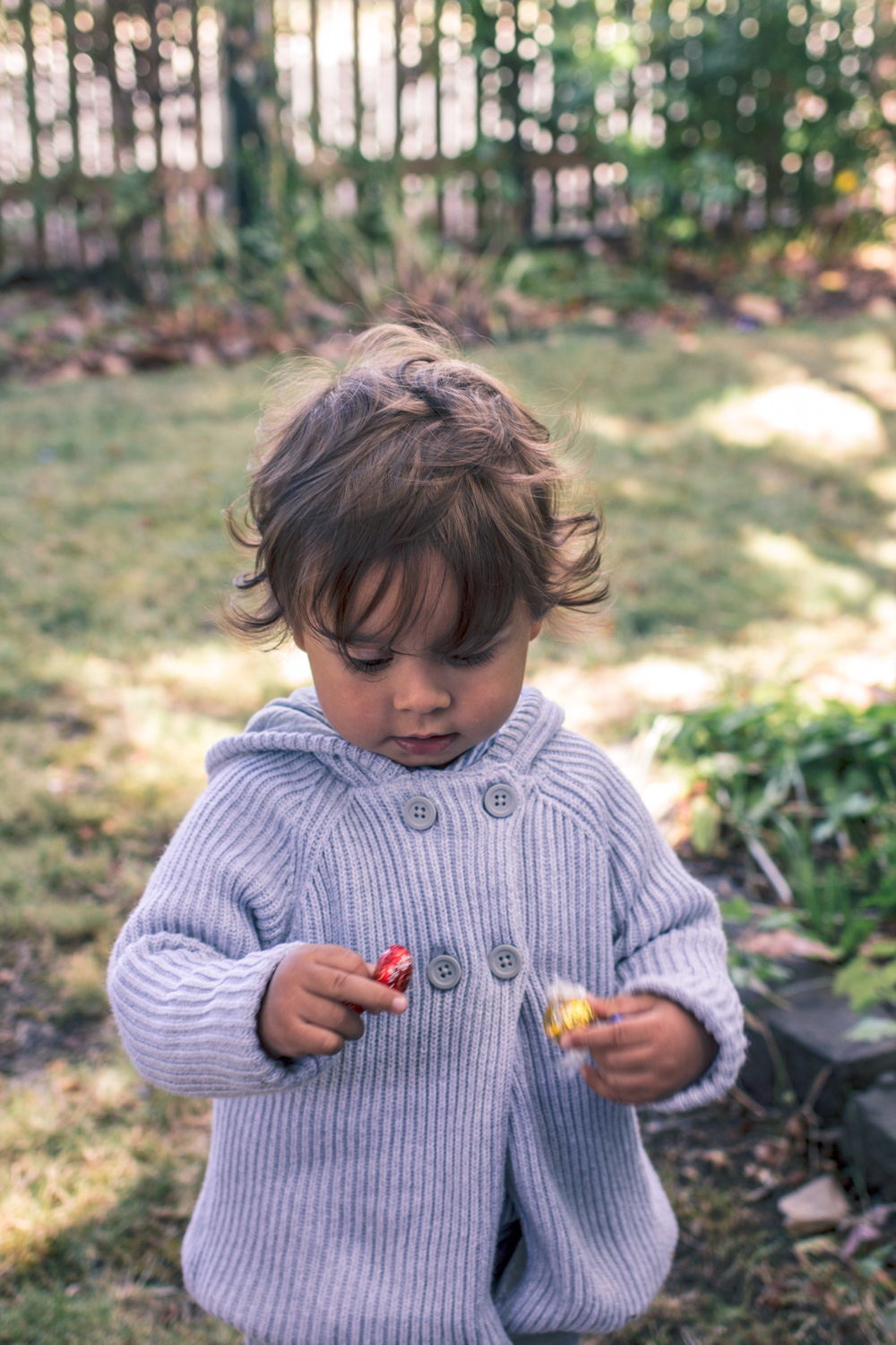 Toddler boy wearing knit cardigan at Autumn Easter Egg Hunt