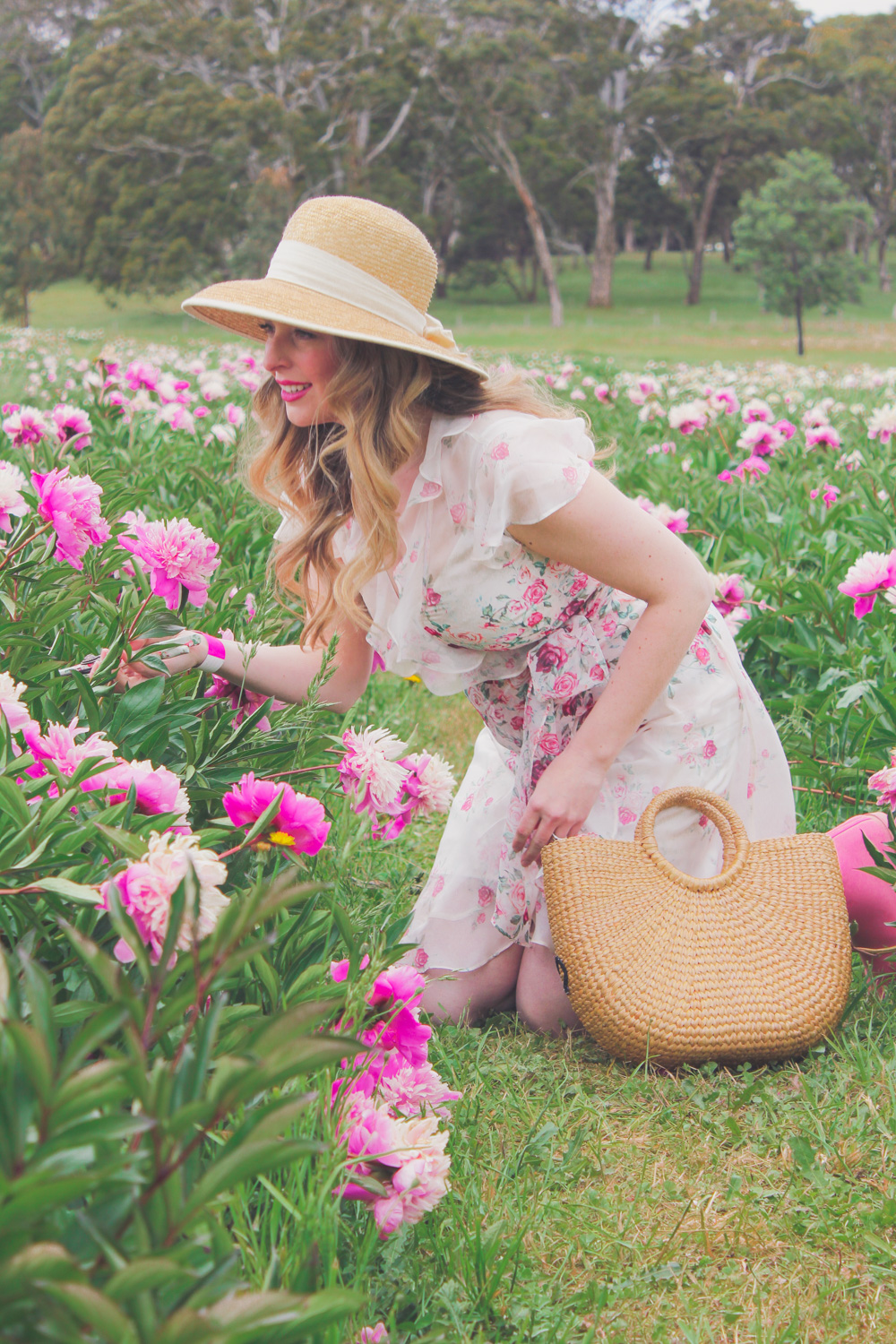 Goldfields Girl standing in the Peony Paddock at Spring Hill Peony Farm wearing an Alannah Hill dress and straw hat