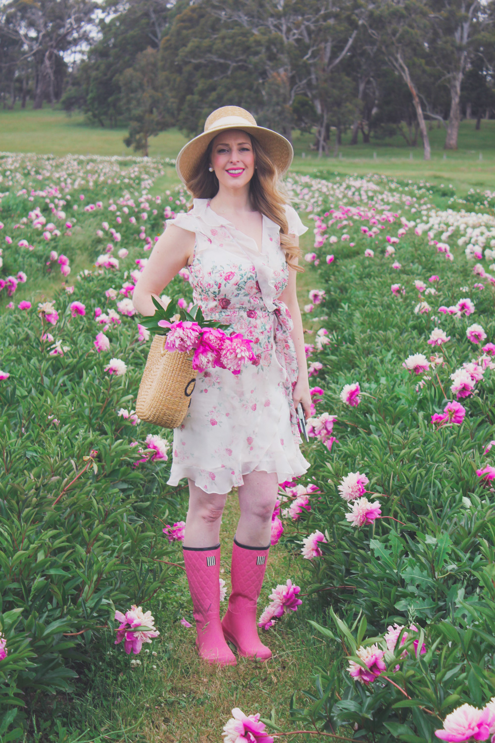 Goldfields Girl standing in the Peony Paddock at Spring Hill Peony Farm wearing an Alannah Hill dress and straw hat