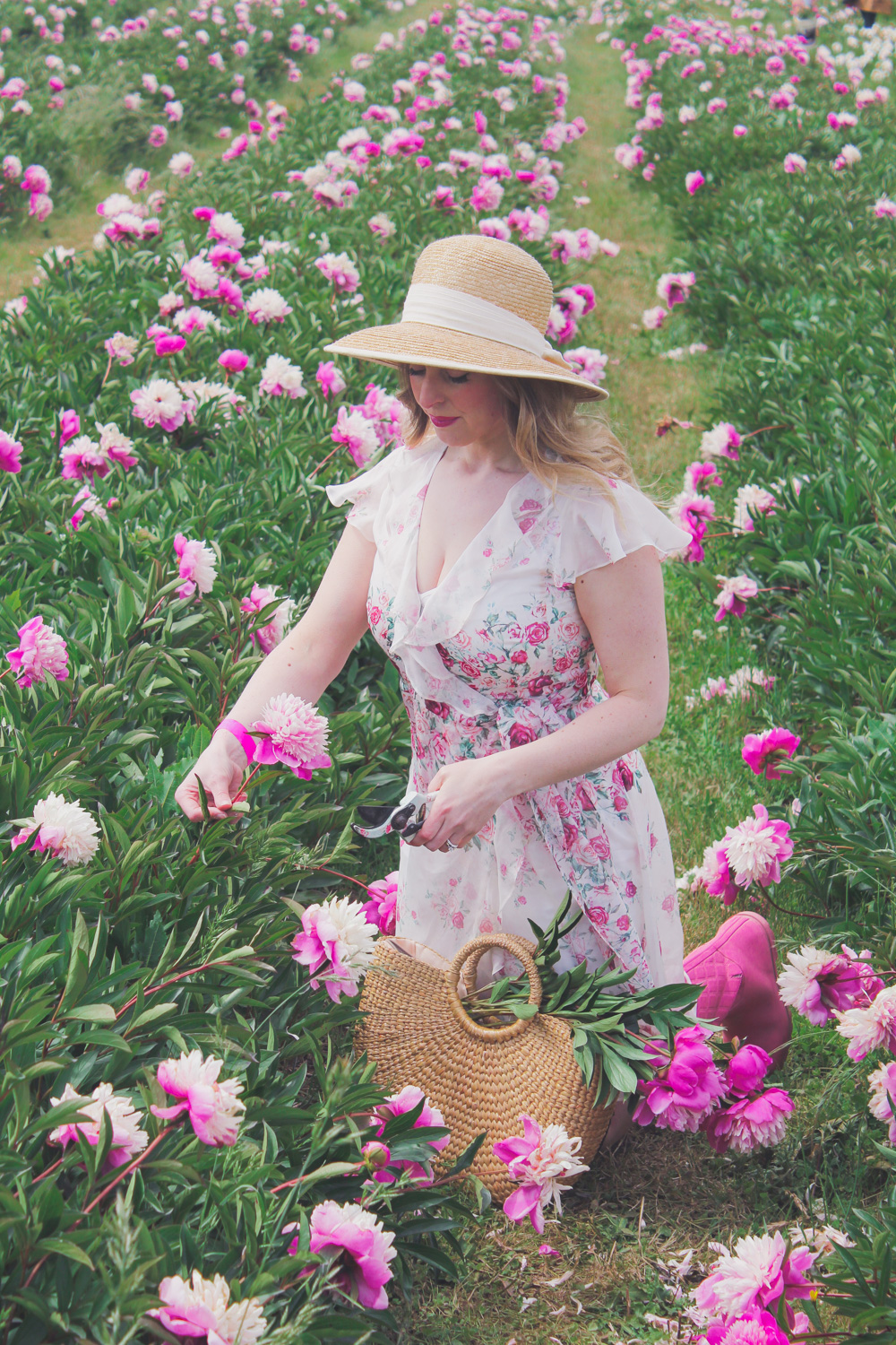 Goldfields Girl standing in the Peony Paddock at Spring Hill Peony Farm wearing an Alannah Hill dress and straw hat