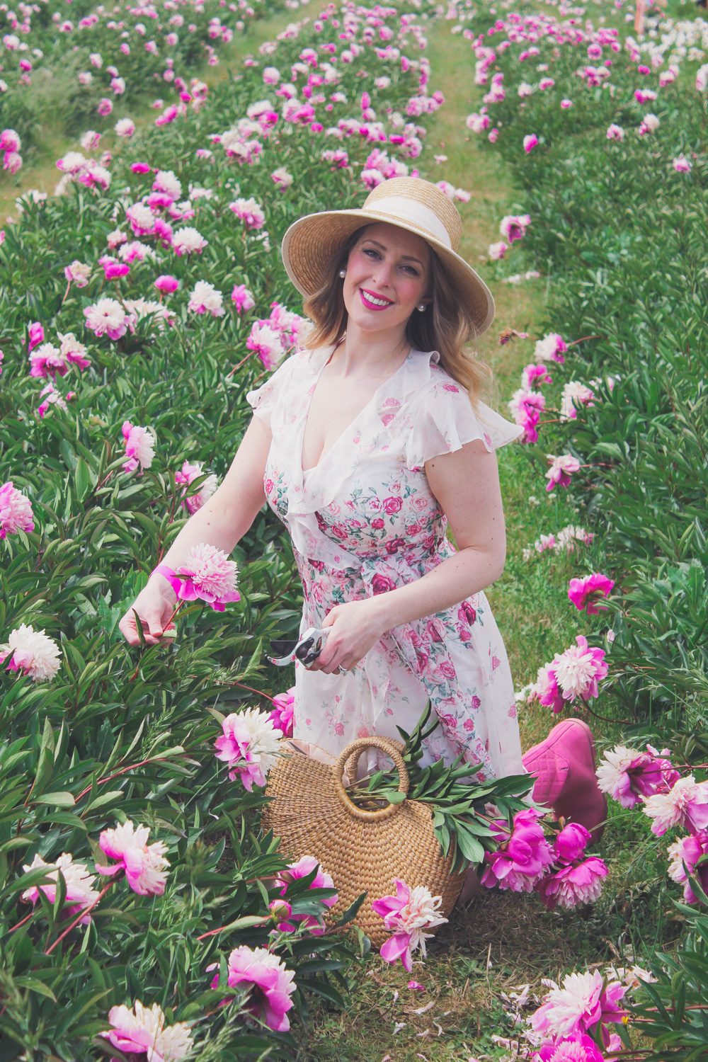 Goldfields Girl standing in the Peony Paddock at Spring Hill Peony Farm wearing an Alannah Hill dress and straw hat