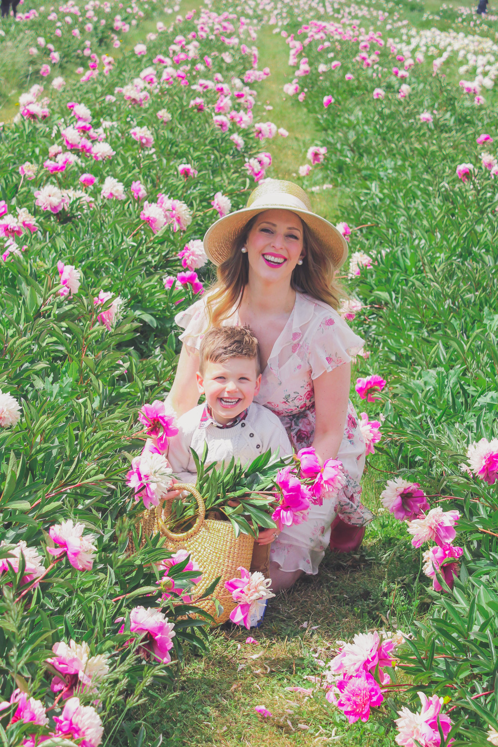 Goldfields Girl standing in the Peony Paddock at Spring Hill Peony Farm wearing an Alannah Hill dress and straw hat