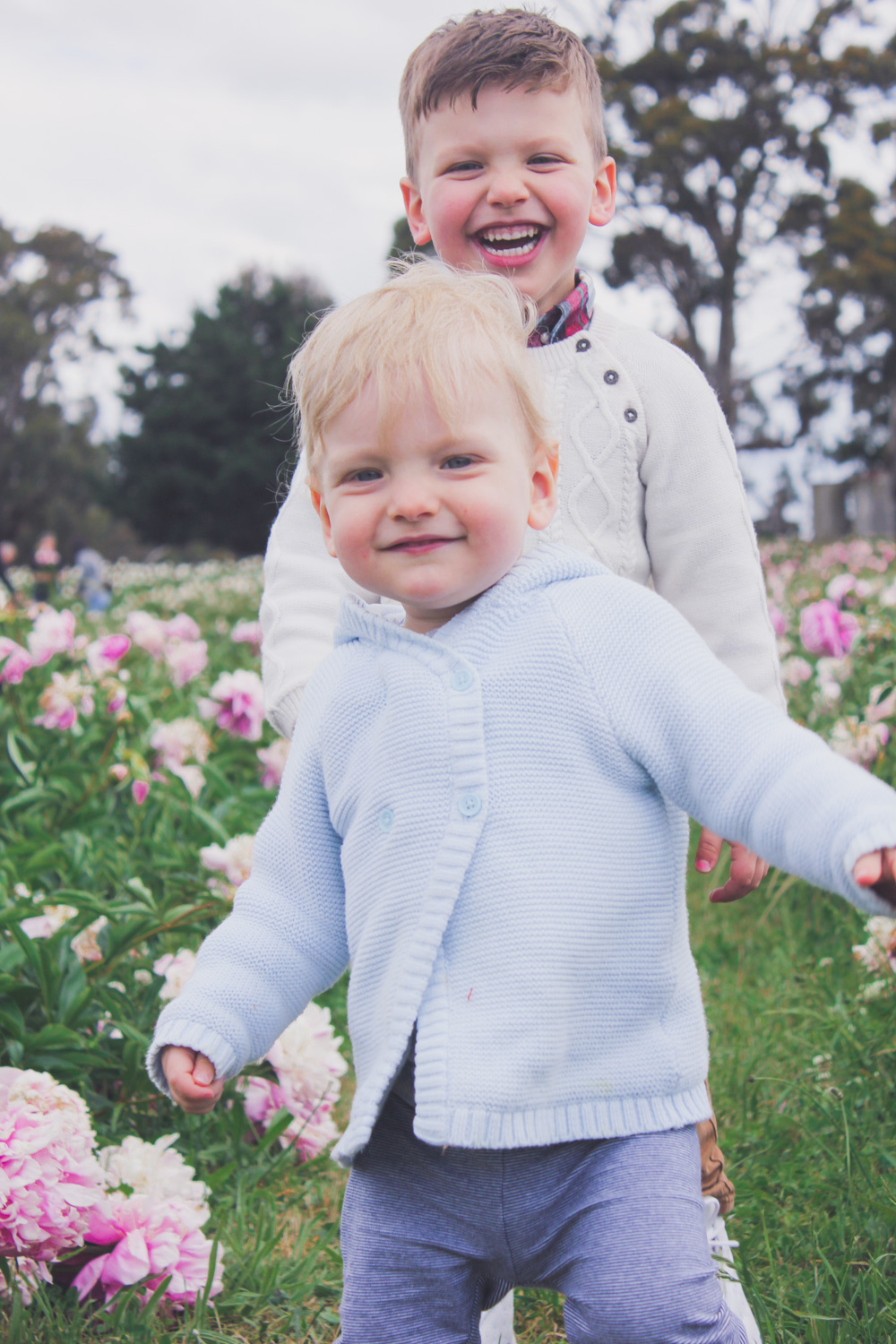 Goldfields Girl standing in the Peony Paddock at Spring Hill Peony Farm wearing an Alannah Hill dress and straw hat