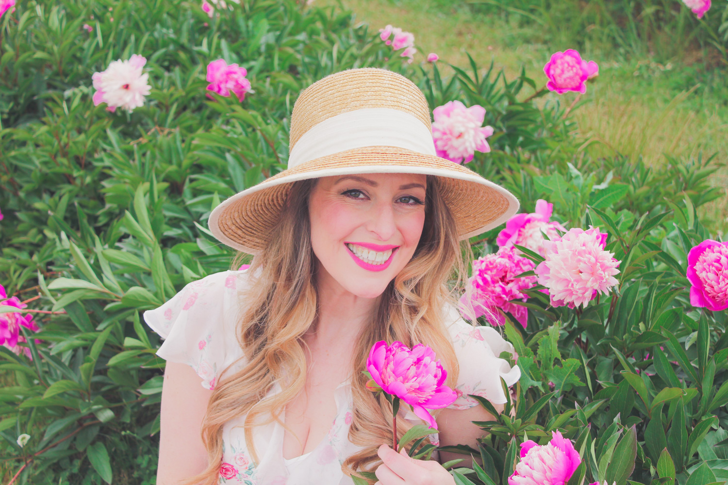 Goldfields Girl standing in the Peony Paddock at Spring Hill Peony Farm wearing an Alannah Hill dress and straw hat