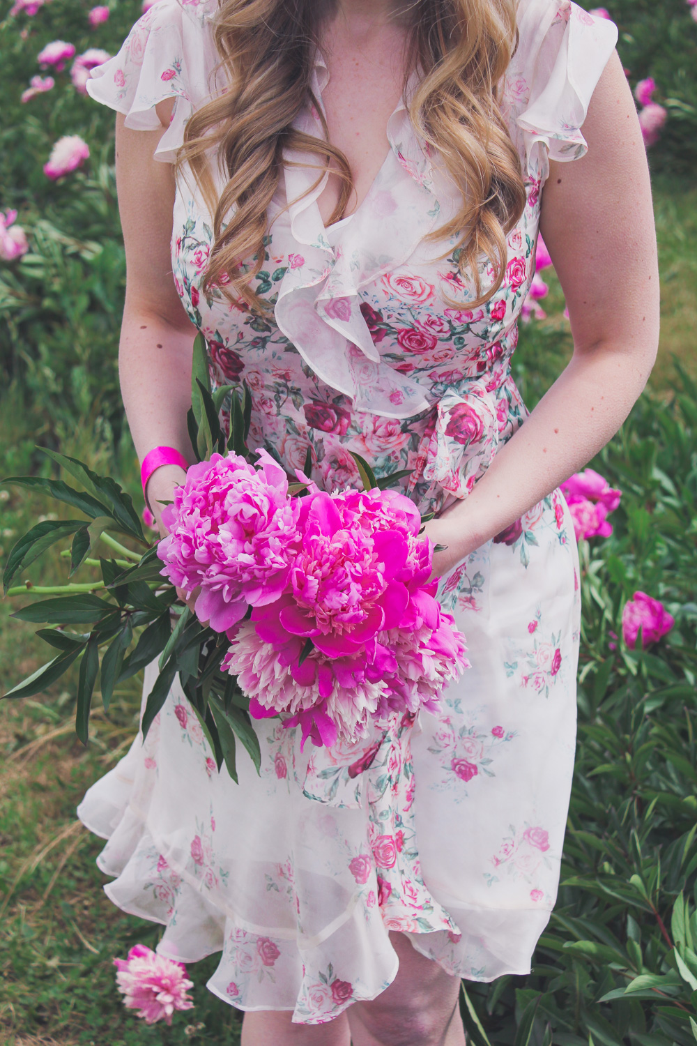 Goldfields Girl standing in the Peony Paddock at Spring Hill Peony Farm wearing an Alannah Hill dress and straw hat