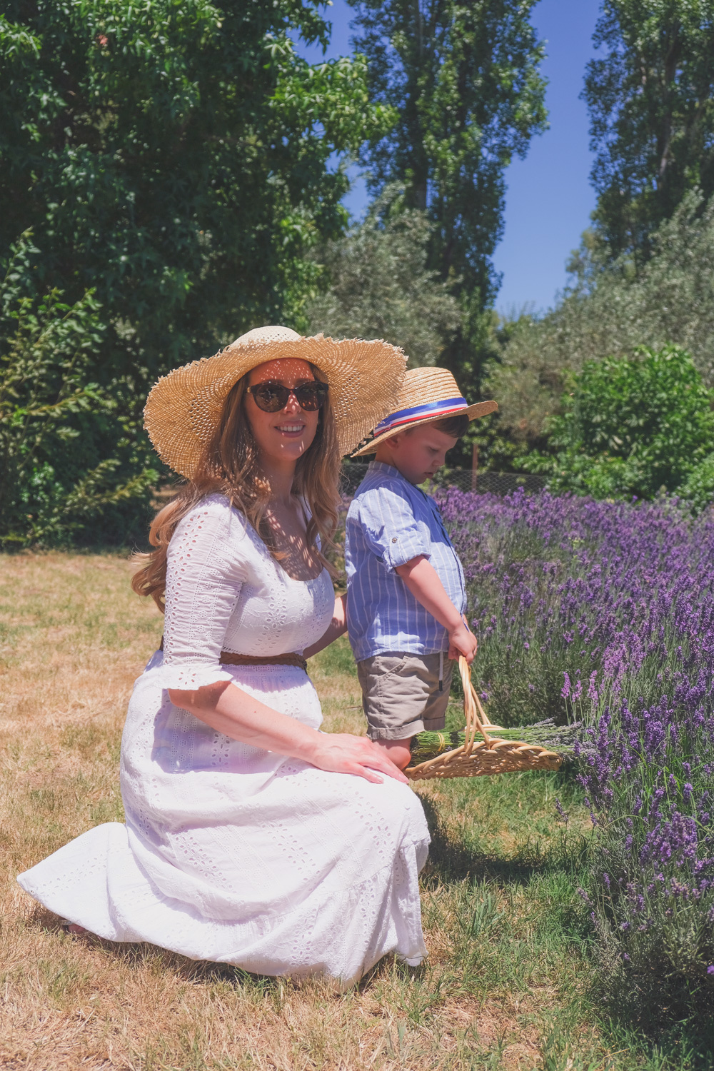 Goldfields Girl and family wearing white summer maternity dress and straw hat at the Harvest Festival at Lavandula Lavender Farm in Daylesford