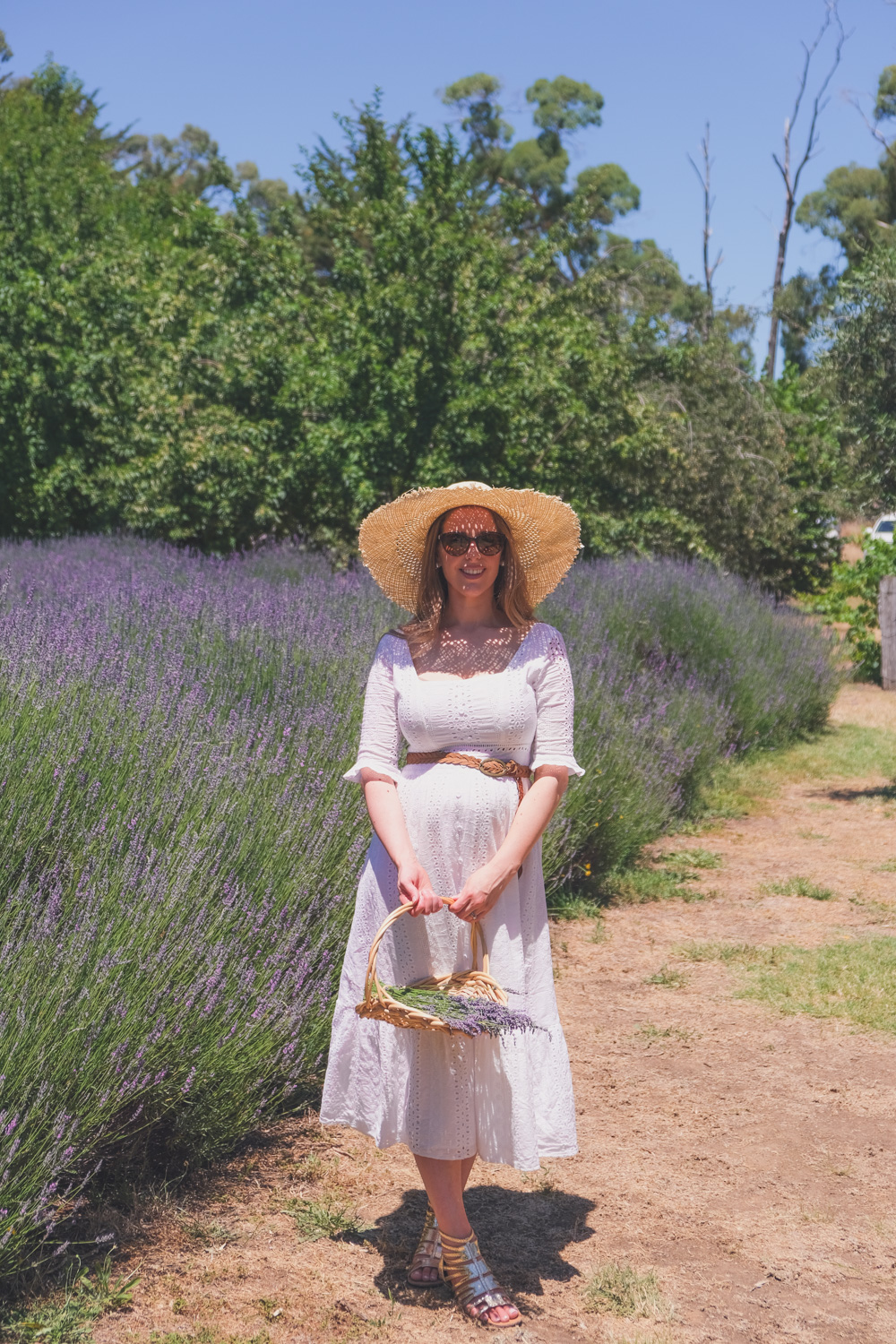 Goldfields Girl and family wearing white summer maternity dress and straw hat at the Harvest Festival at Lavandula Lavender Farm in Daylesford