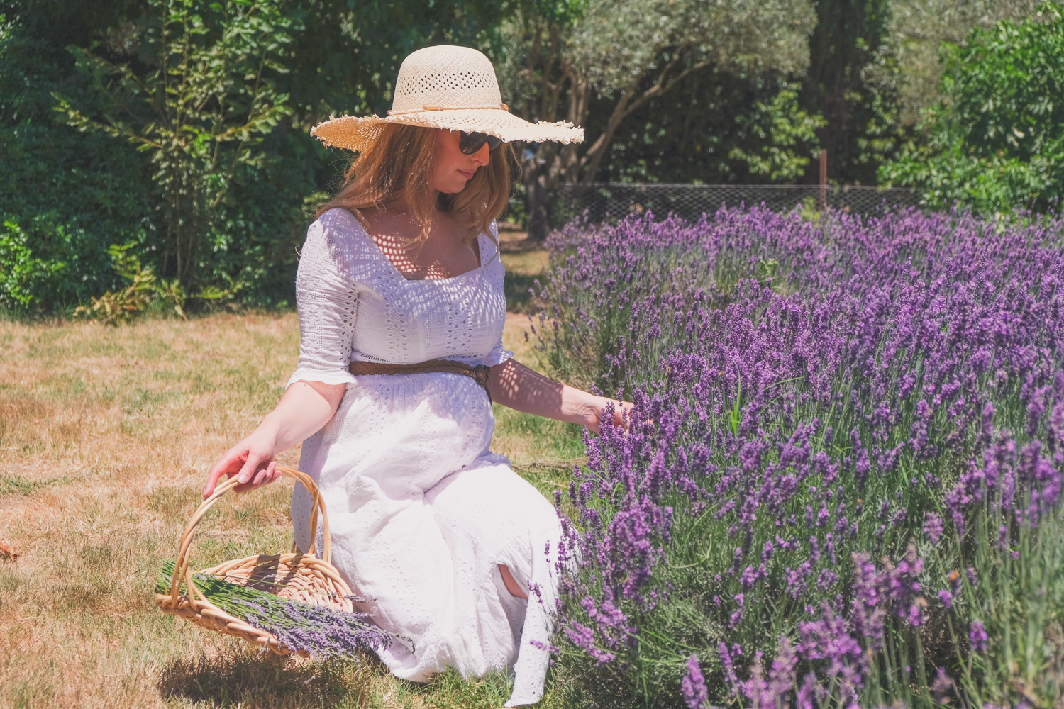 Goldfields Girl and family wearing white summer maternity dress and straw hat at the Harvest Festival at Lavandula Lavender Farm in Daylesford