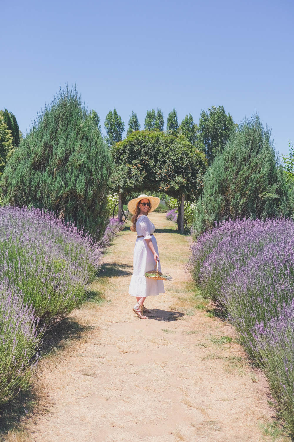 Goldfields Girl and family wearing white summer maternity dress and straw hat at the Harvest Festival at Lavandula Lavender Farm in Daylesford