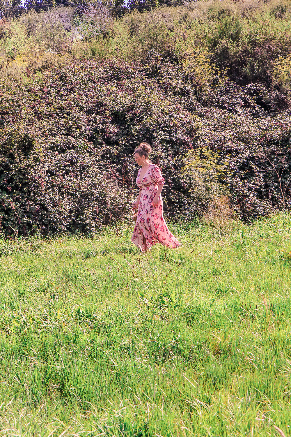 Goldfields Girl wearing pretty red and pin floral dress while blackberry picking