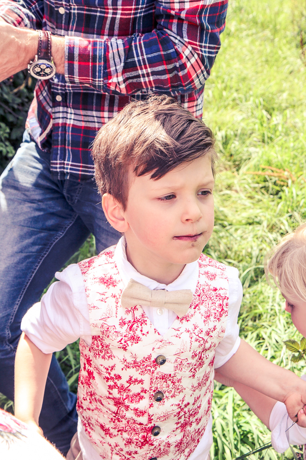 Little boy wearing bow tie and red toile vest