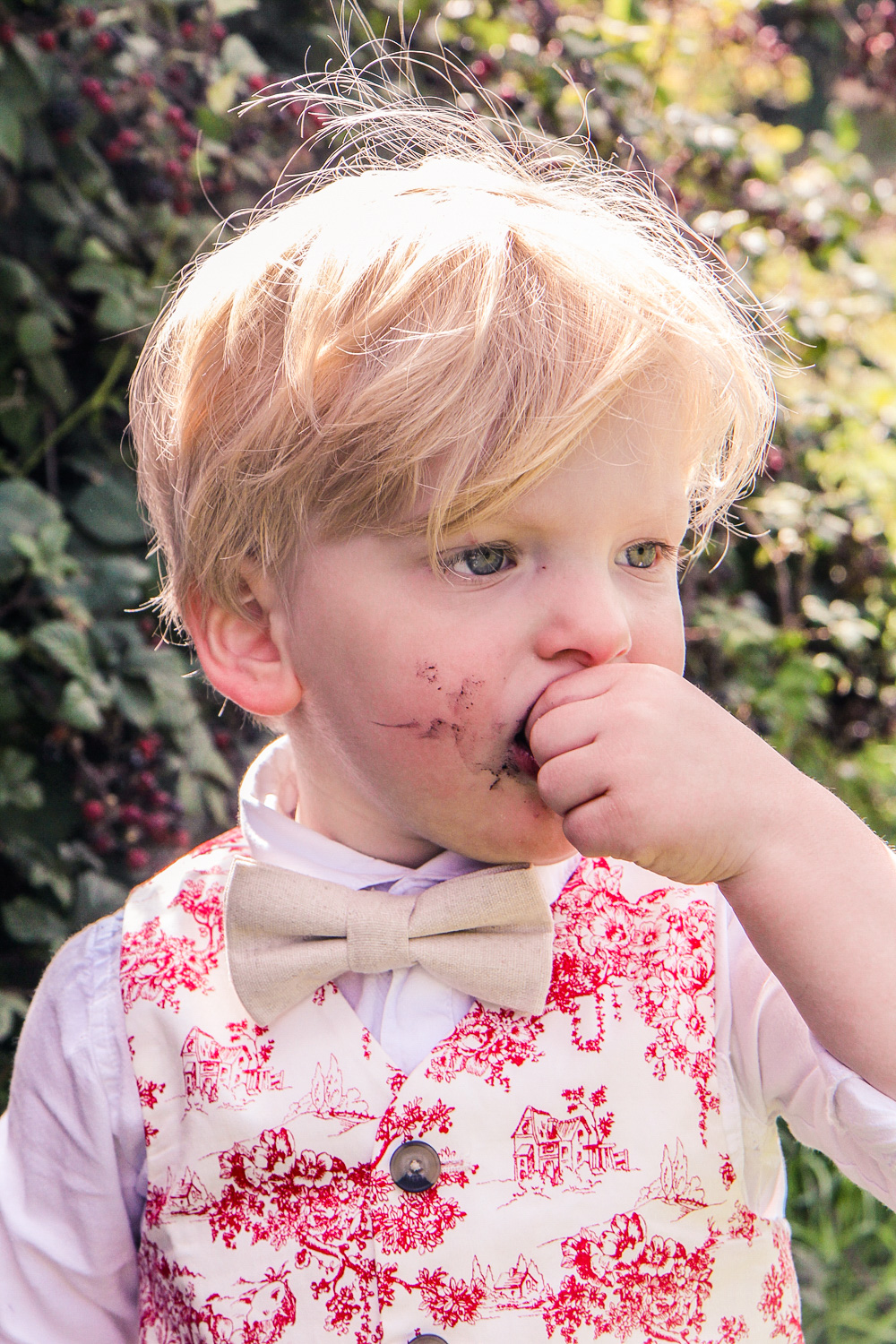 Little boy wearing Janie and Jack bow tie with red toile vest