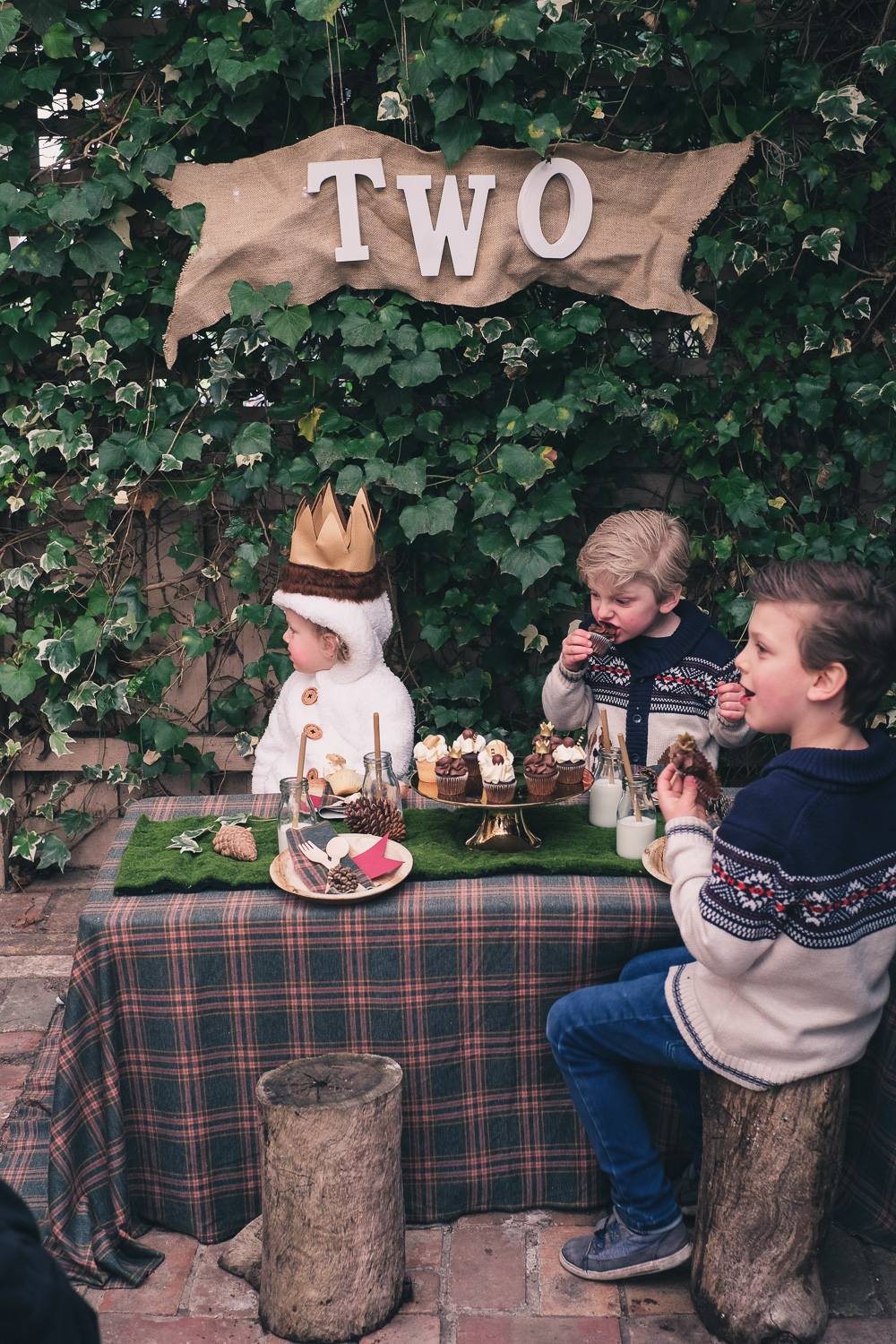 Children seated at Where The Wild Things Are party table eating cake