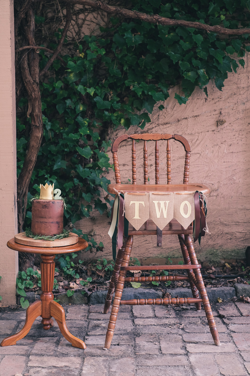 Where The Wild Things Are vintage birthday high chair decorated with bunting and ribbon with birthday cake with crown